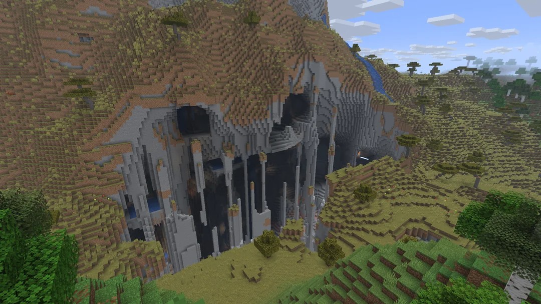 Minecraft seed with a rocky cliff that looks like a monster face near spawn (-6044780343592149694)